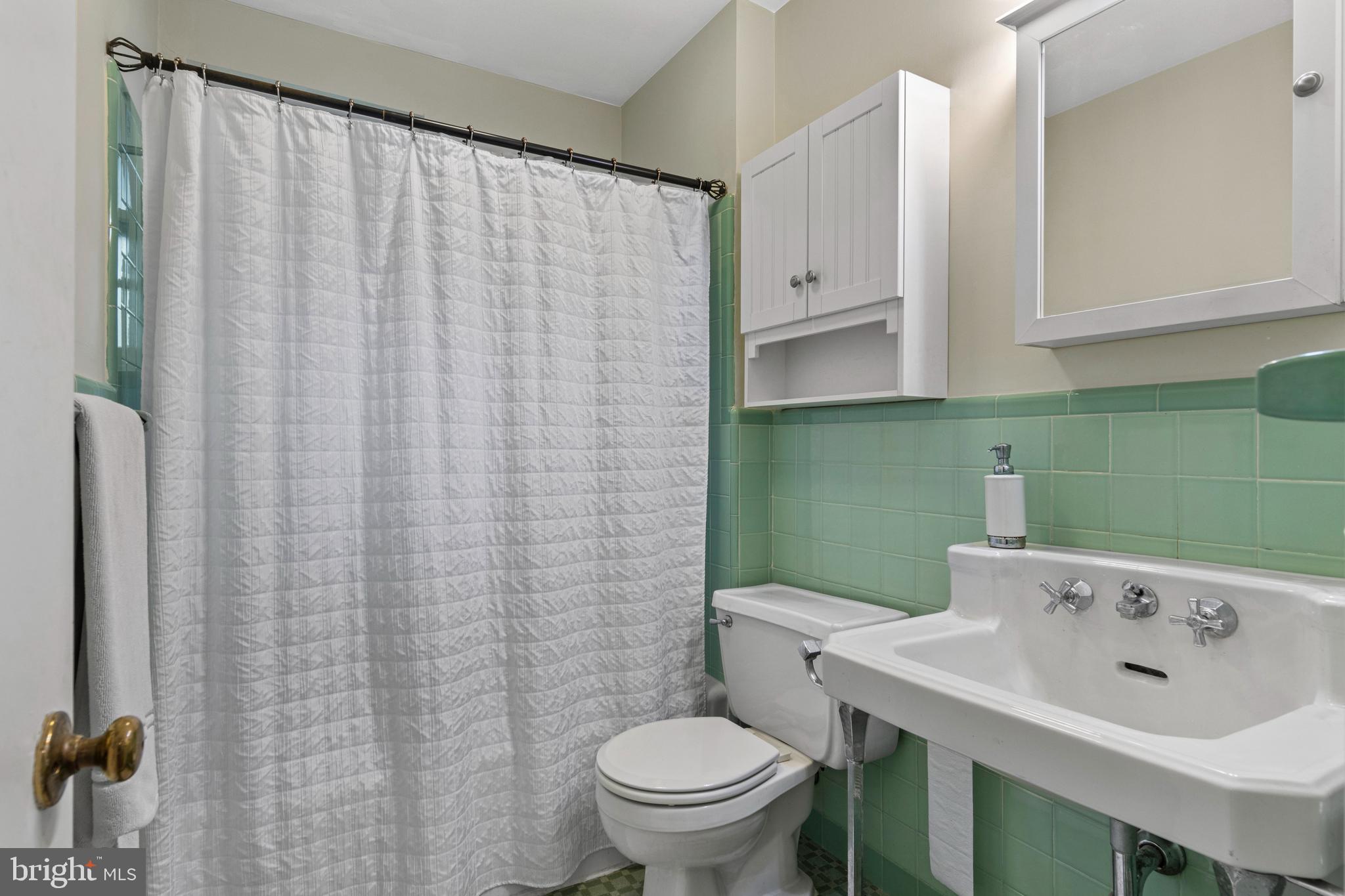 413 Hawthorne Road Wallingford, PA 19086 - Photo 33 of 52 a bathroom with a sink a toilet and a mirror