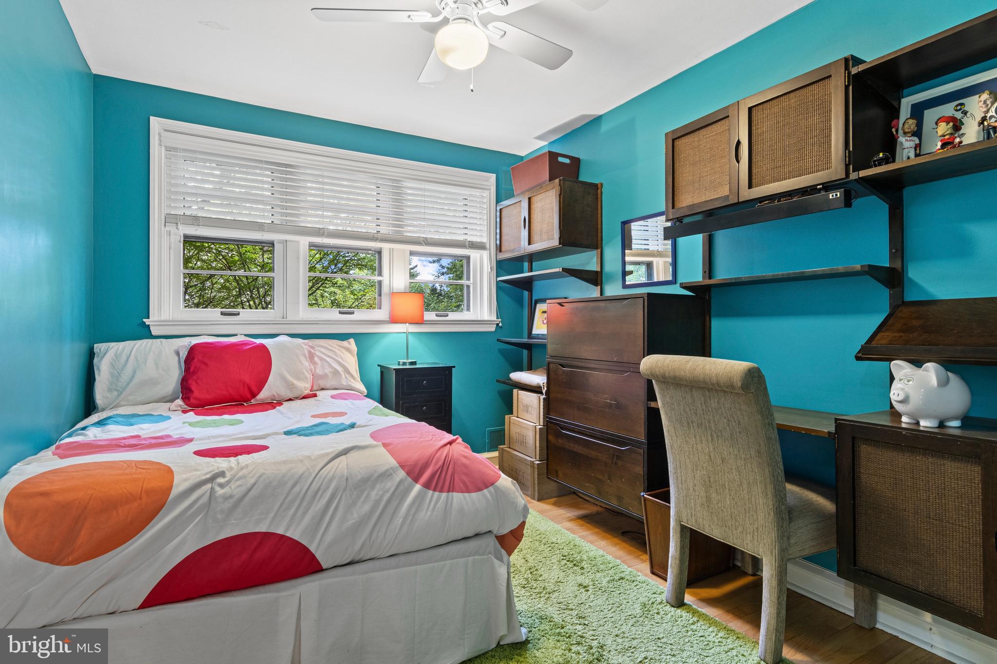 413 Hawthorne Road Wallingford, PA 19086 - Photo 35 of 52 a bedroom with a bed and a chair with the bookshelf