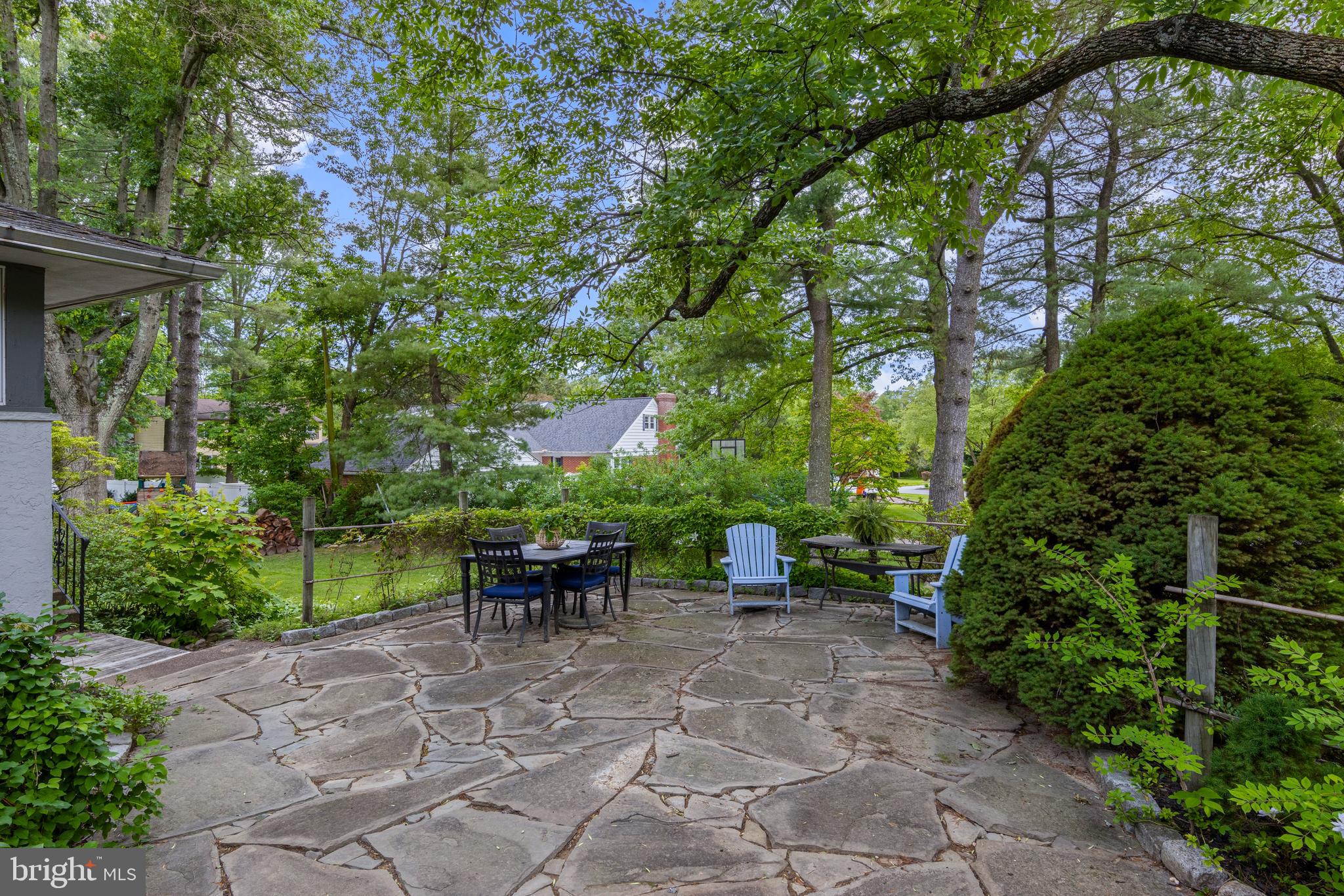 413 Hawthorne Road Wallingford, PA 19086 - Photo 36 of 52 a view of a patio with table and chairs potted plants and large tree