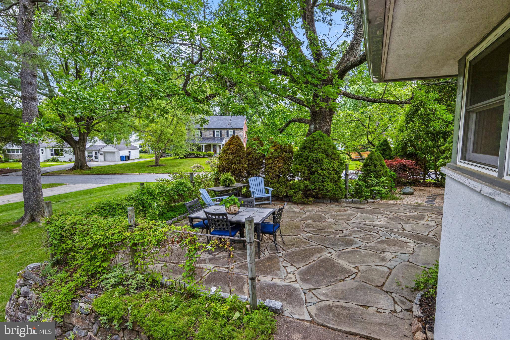 413 Hawthorne Road Wallingford, PA 19086 - Photo 37 of 52 a view of a patio with table and chairs potted plants and large tree