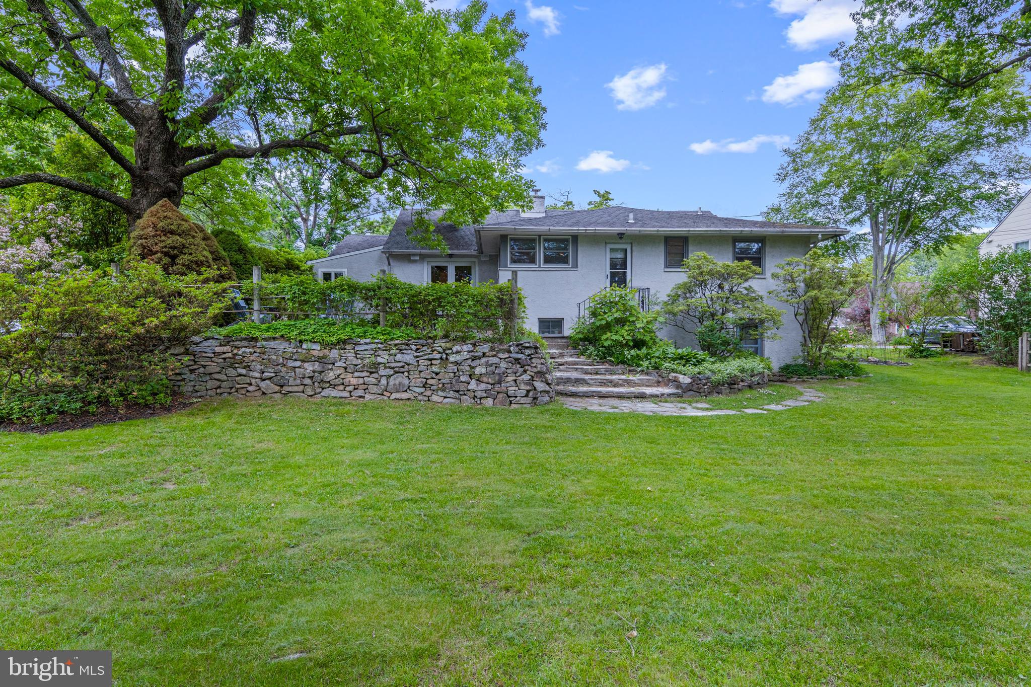 413 Hawthorne Road Wallingford, PA 19086 - Photo 39 of 52 a front view of a house with a garden