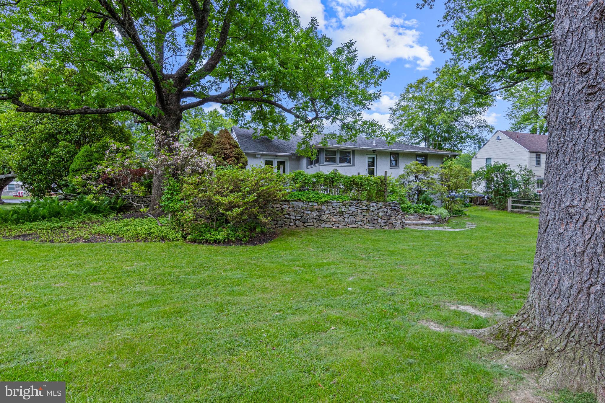 413 Hawthorne Road Wallingford, PA 19086 - Photo 4 of 52 a view of a garden with a tree