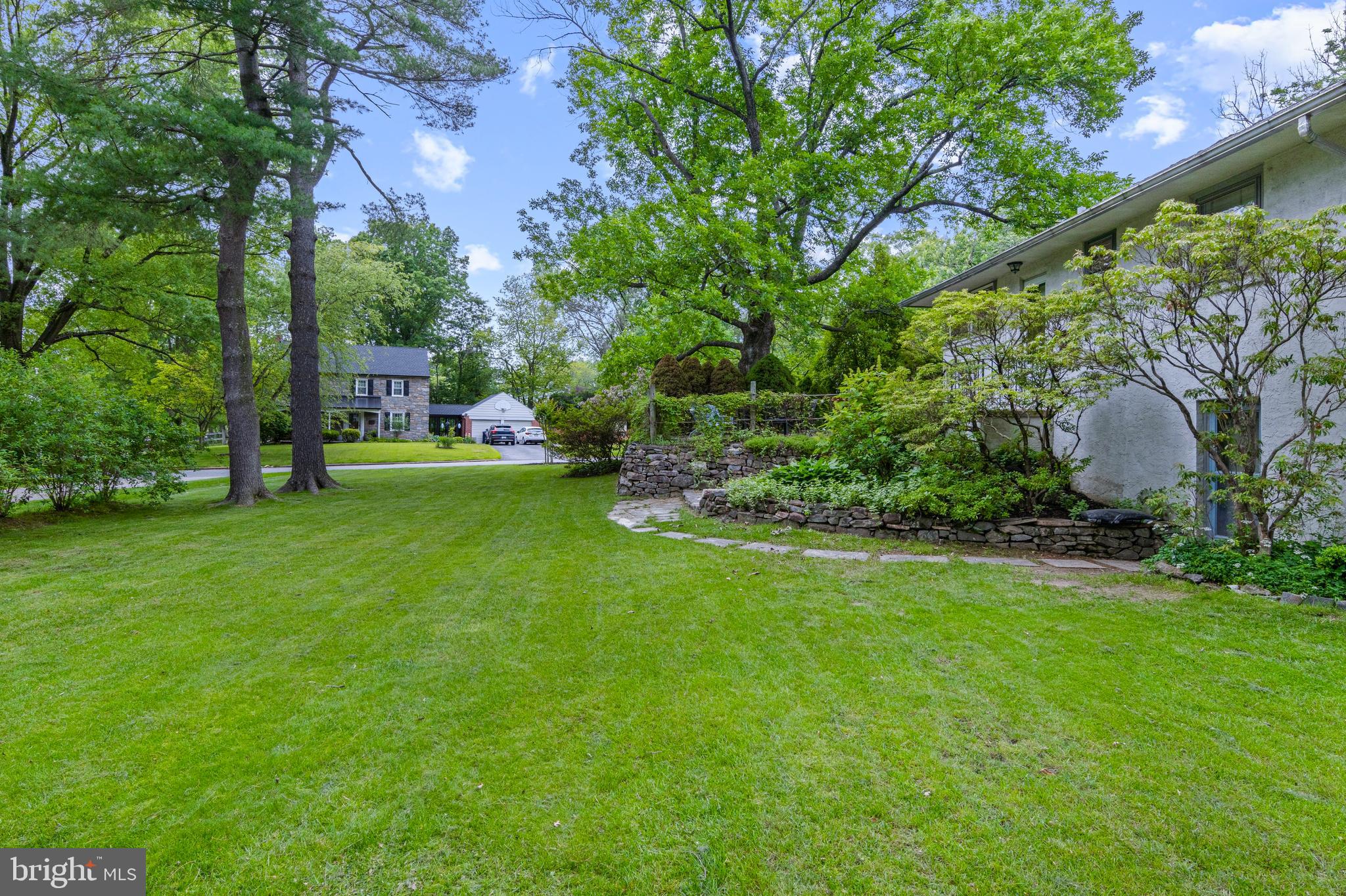 413 Hawthorne Road Wallingford, PA 19086 - Photo 42 of 52 a view of a backyard with a garden and trees