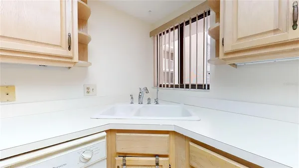 a kitchen with white cabinets and appliances