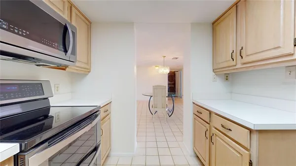 a kitchen with white cabinets and refrigerator