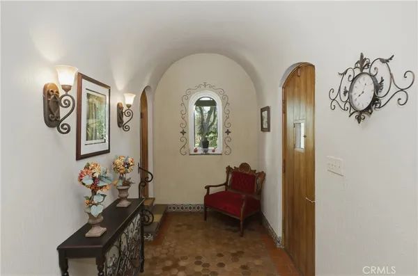 a dining room with furniture a chandelier and window