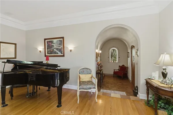 a large kitchen with stainless steel appliances kitchen island granite countertop a large center island a sink dishwasher a stove and a dining table with wooden floor