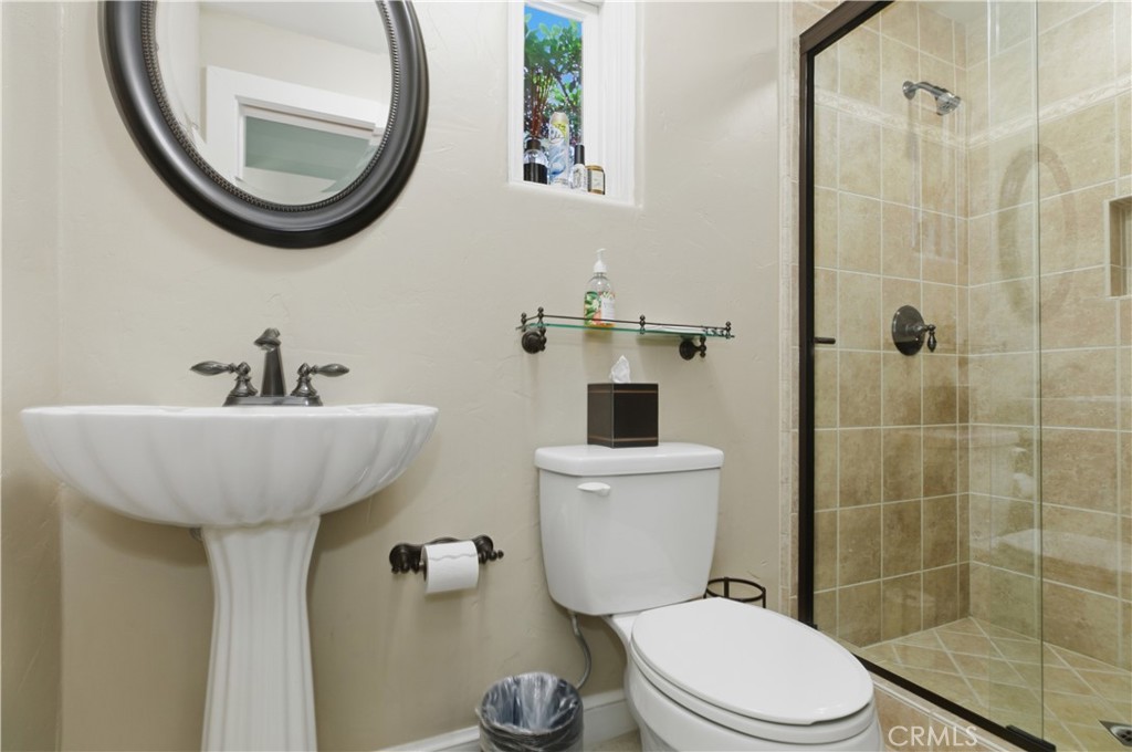 2855 McAllister Street Riverside, CA 92503 - Photo 42 of 75 a bathroom with a sink a toilet and a mirror