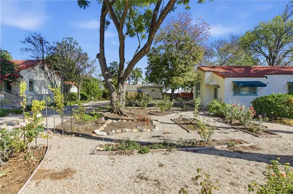 a view of a fountain in the patio with a small yard