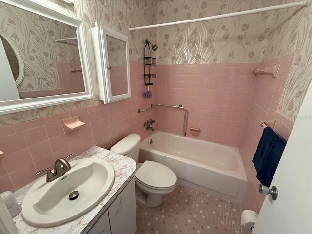 a bathroom with a sink a toilet and a bathtub