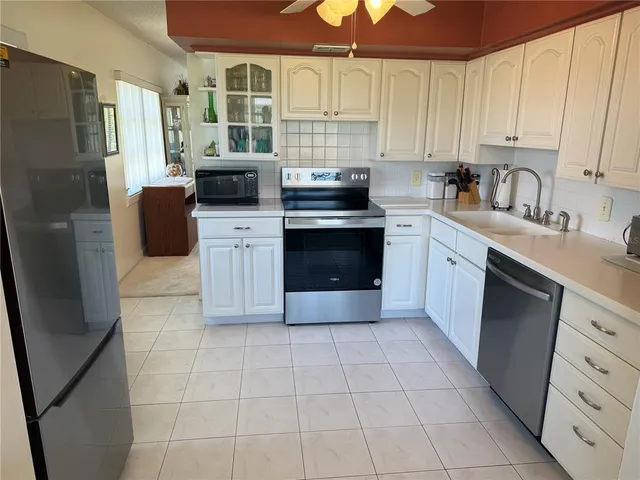 a kitchen with a stove a sink and a refrigerator