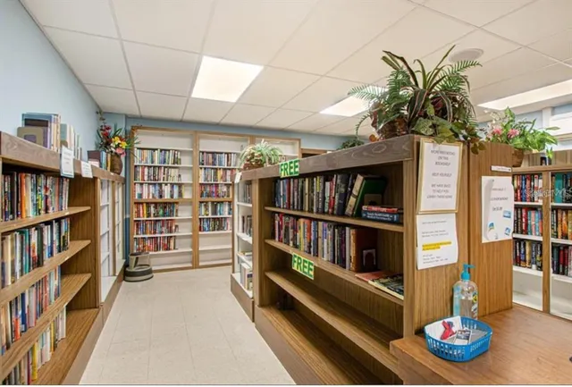 a living room with a book shelf and a book shelf