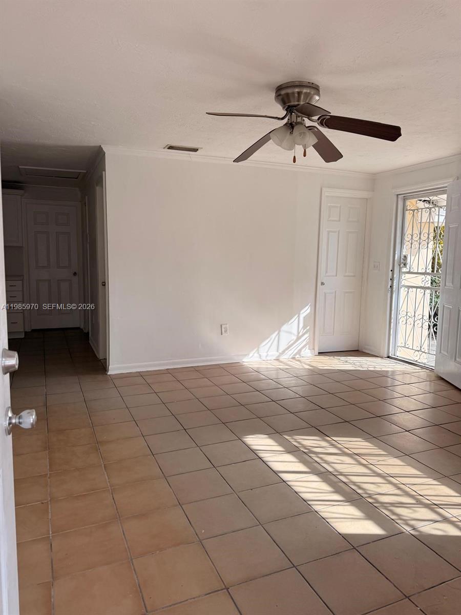 409 Northwest 33rd Street, Unit 1 Miami, FL 33127 - Photo 6 of 17 a view of a livingroom with a ceiling fan and window