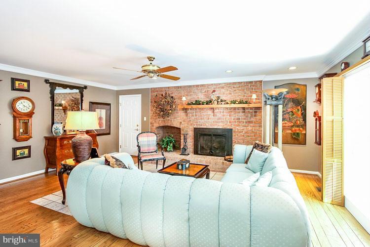 20801 Layton Ridge Drive Gaithersburg, MD 20882 - Photo 11 of 30 a living room with fireplace furniture and a floor to ceiling window
