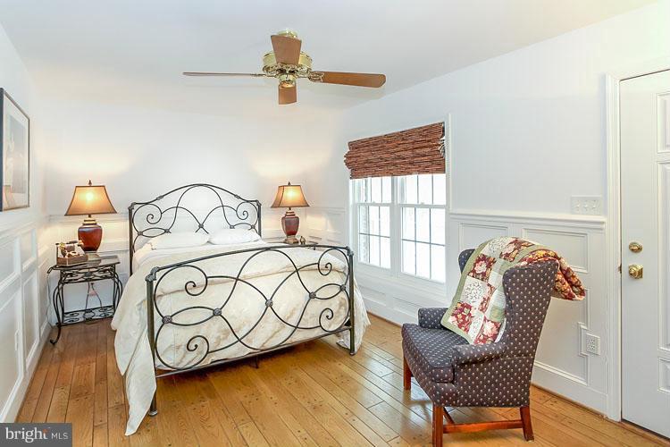 20801 Layton Ridge Drive Gaithersburg, MD 20882 - Photo 12 of 30 a bedroom with a bed and wooden floor