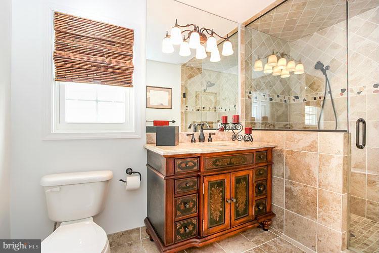 20801 Layton Ridge Drive Gaithersburg, MD 20882 - Photo 13 of 30 a bathroom with a sink a toilet a mirror and a shower
