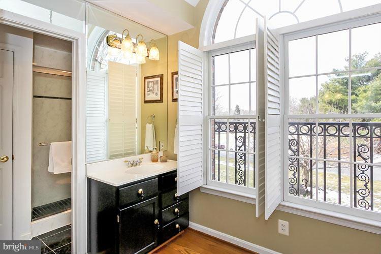 20801 Layton Ridge Drive Gaithersburg, MD 20882 - Photo 15 of 30 a bathroom with a sink a mirror and next to a window
