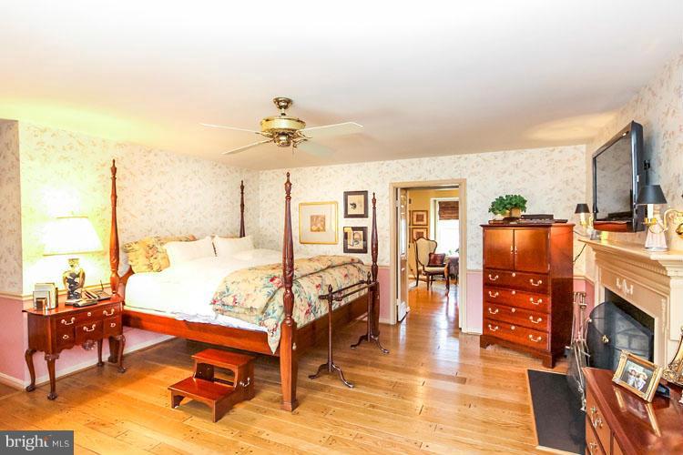 20801 Layton Ridge Drive Gaithersburg, MD 20882 - Photo 16 of 30 a spacious bedroom with a bed and wooden floor