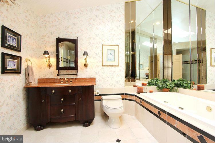 20801 Layton Ridge Drive Gaithersburg, MD 20882 - Photo 18 of 30 a spacious bathroom with a granite countertop tub sink and mirror