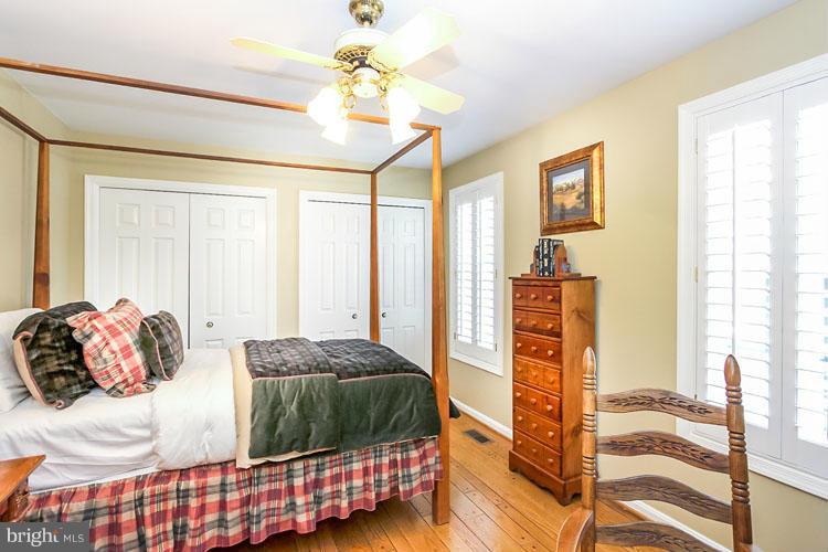 20801 Layton Ridge Drive Gaithersburg, MD 20882 - Photo 19 of 30 a bedroom with a bed and wooden floor