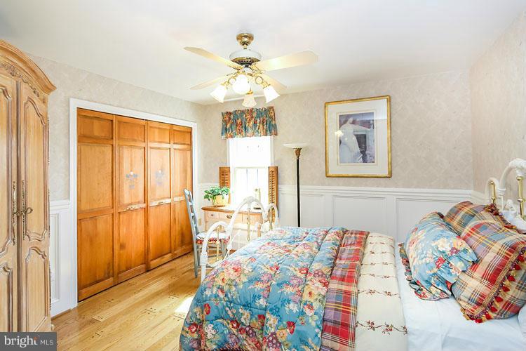 20801 Layton Ridge Drive Gaithersburg, MD 20882 - Photo 20 of 30 a bedroom with a bed and a chandelier