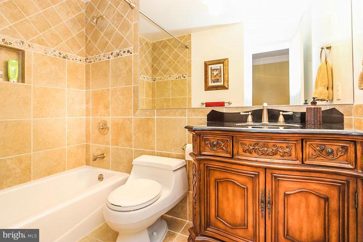 20801 Layton Ridge Drive Gaithersburg, MD 20882 - Photo 21 of 30 a bathroom with a granite countertop toilet sink and mirror