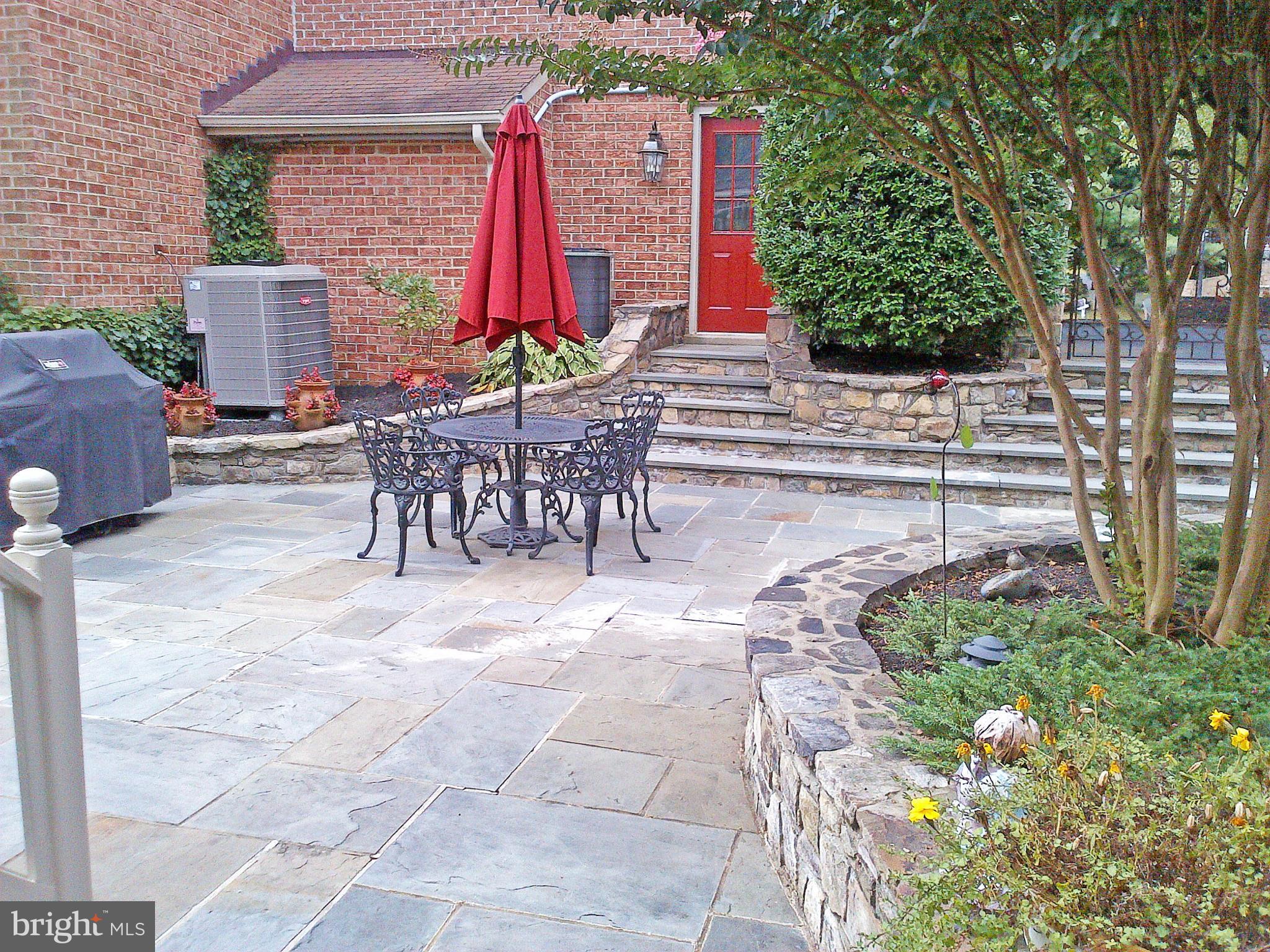 20801 Layton Ridge Drive Gaithersburg, MD 20882 - Photo 30 of 30 a view of a patio with table and chairs potted plants
