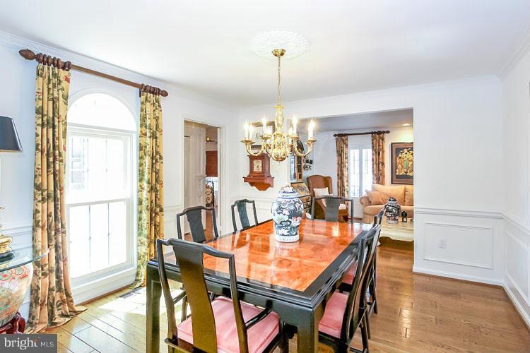 20801 Layton Ridge Drive Gaithersburg, MD 20882 - Photo 5 of 30 a dining room with furniture a chandelier and wooden floor