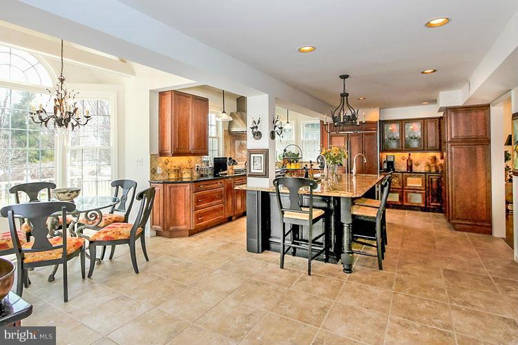 20801 Layton Ridge Drive Gaithersburg, MD 20882 - Photo 6 of 30 a dining area with glass top table and chairs