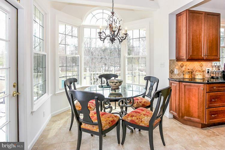20801 Layton Ridge Drive Gaithersburg, MD 20882 - Photo 10 of 30 a dining room with furniture a chandelier and wooden floor