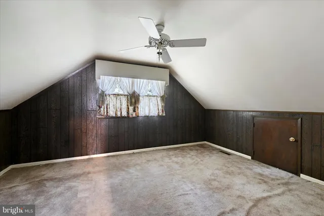 a view of empty room with a fireplace