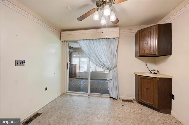 a kitchen with stainless steel appliances granite countertop a refrigerator a stove and a sink with wooden cabinets