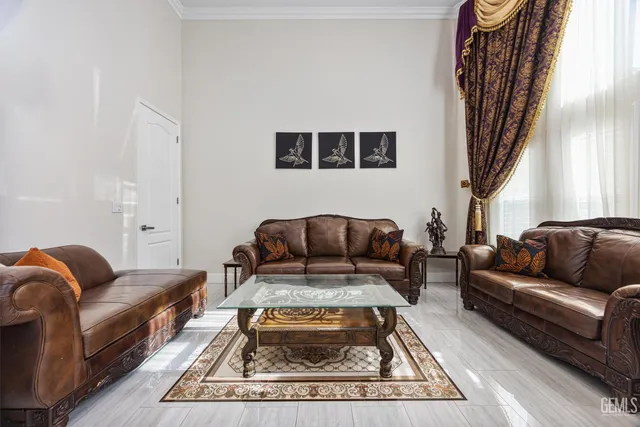 a living room with furniture ceiling fan and a flat screen tv