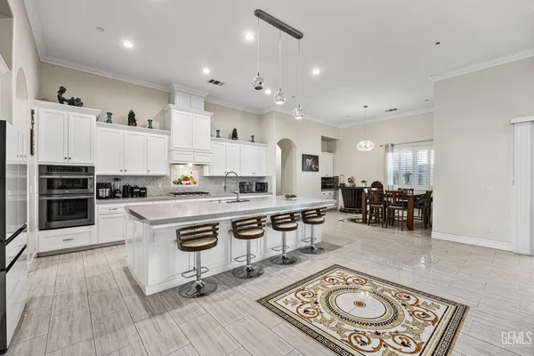 a living room with furniture ceiling fan and a flat screen tv