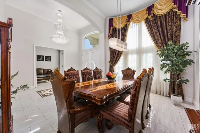 a kitchen with stainless steel appliances granite countertop a table chairs stove a sink dishwasher and cabinets