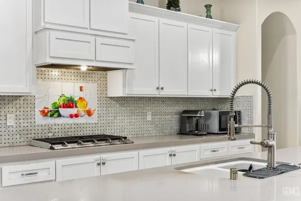 a kitchen with a stove a sink and a refrigerator
