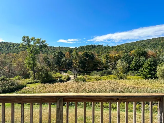 a view of balcony with wooden floor and fence