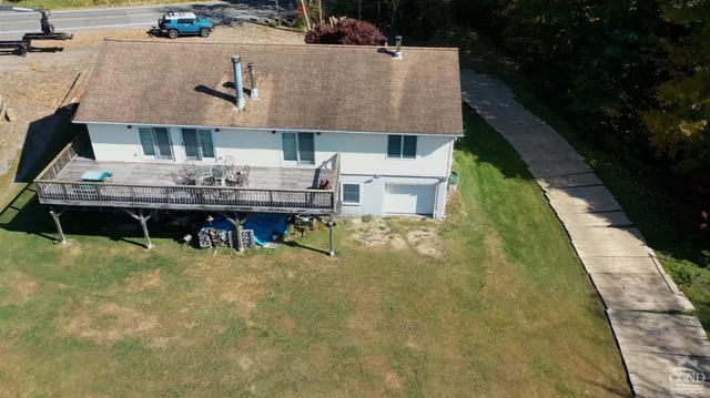 a aerial view of a house with table and chairs