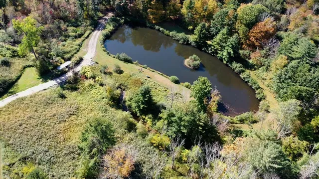 an aerial view of lake residential house with swimming pool and outdoor space