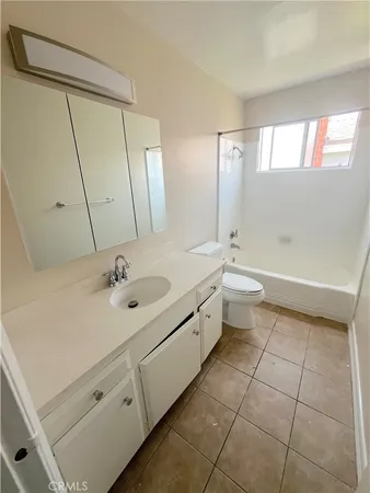 a bathroom with a double vanity sink toilet and mirror