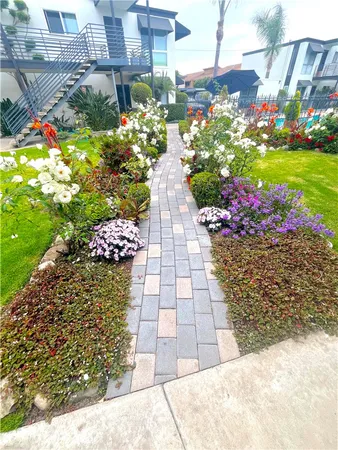 a view of a pathway with flower pots