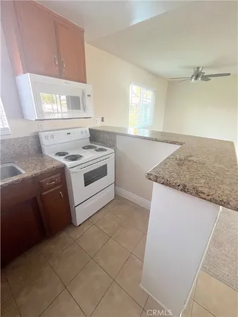 a kitchen with a stove a sink and a refrigerator