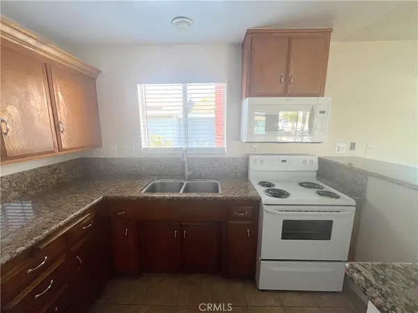 a kitchen with a stove sink and window