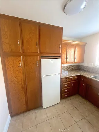 a kitchen with a refrigerator and cabinets