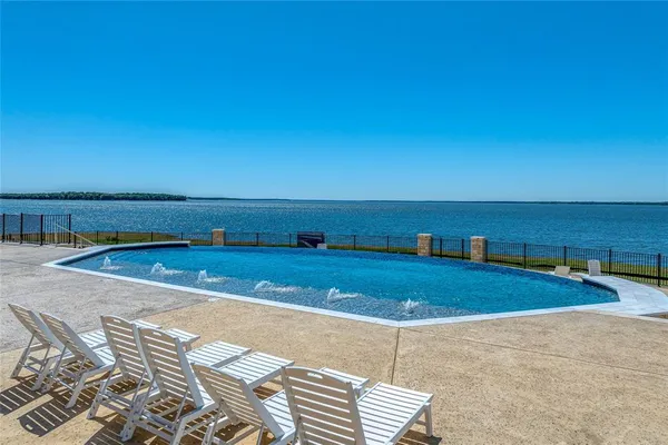 a view of a swimming pool with a lounge chair