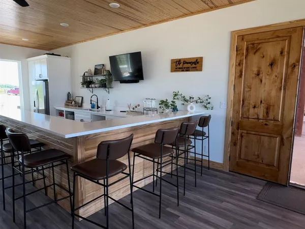 a living room with lots of furniture and a wooden floor