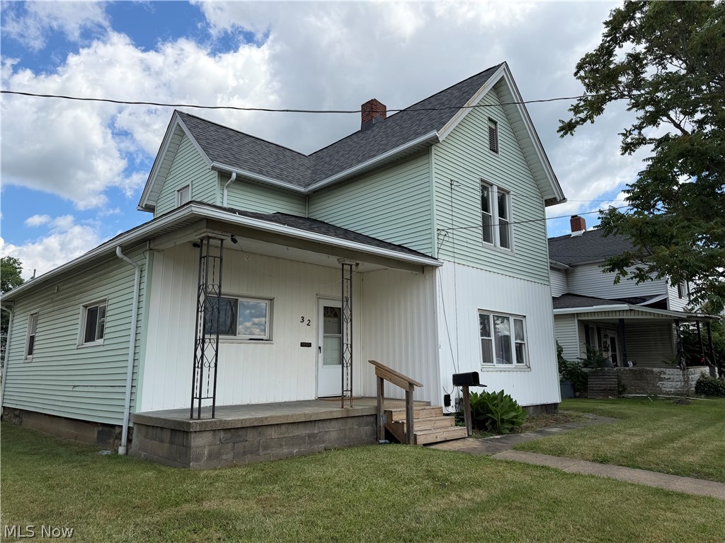 Two-story exterior with light green and white siding
