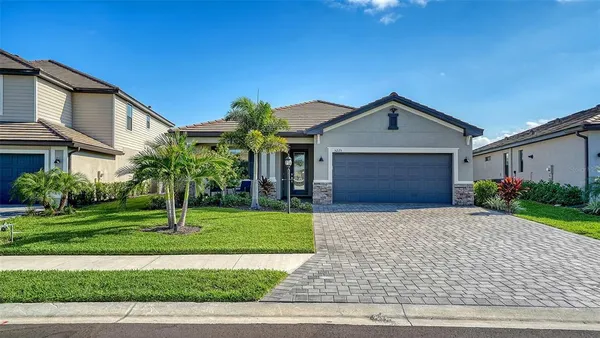 a front view of a house with a yard and garage
