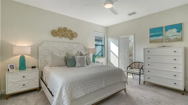 a bedroom with a bed and a flat tv screen on the dresser