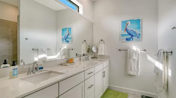 a bedroom with a bed and wall painting